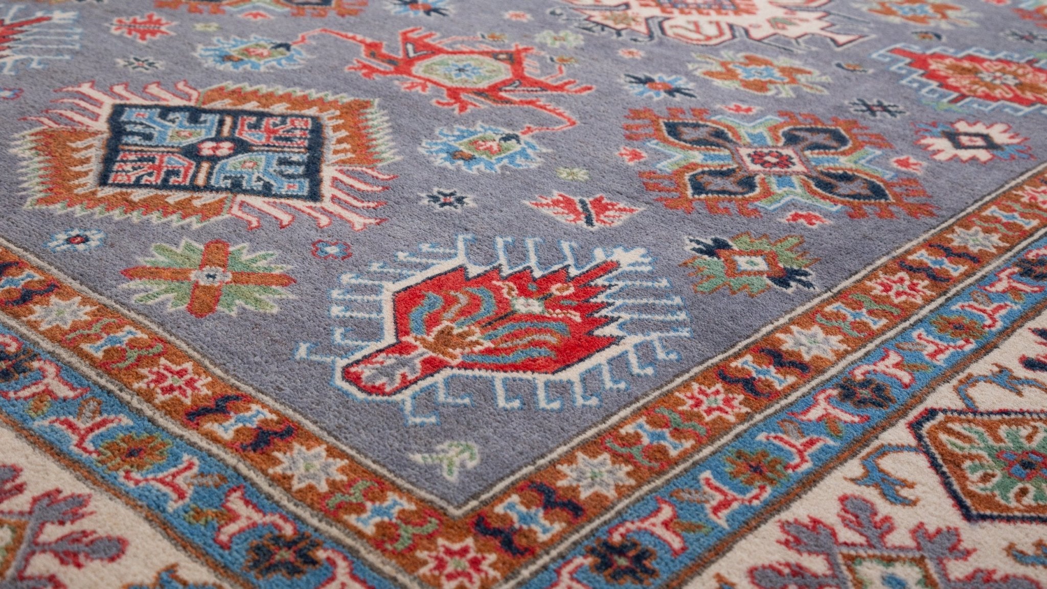 Pattern detail of blue & red Kazak-inspired wool rug 29339.