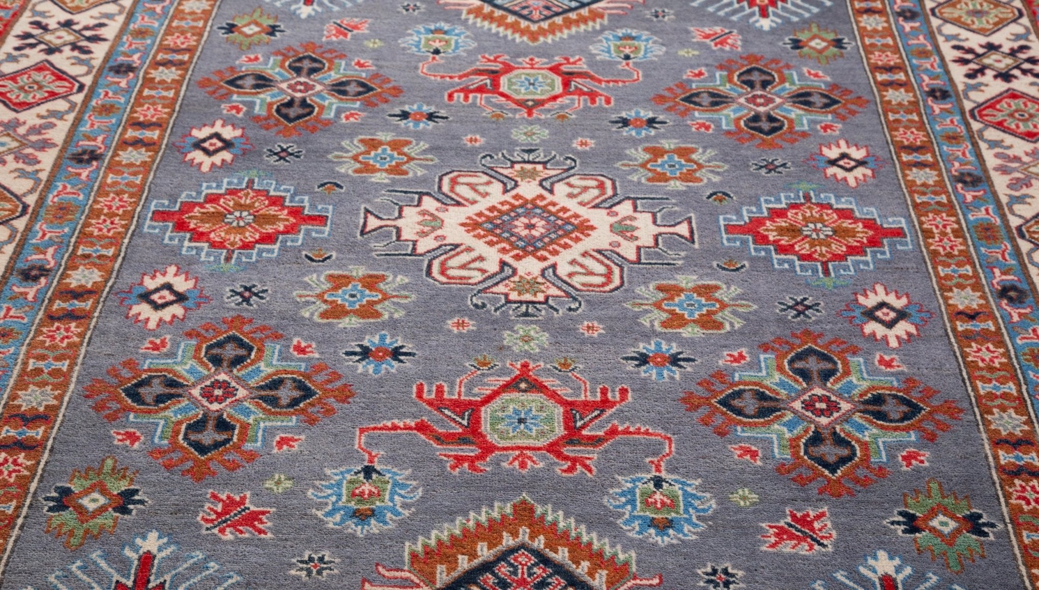 Pattern detail of blue & red Kazak-inspired wool rug 29339.