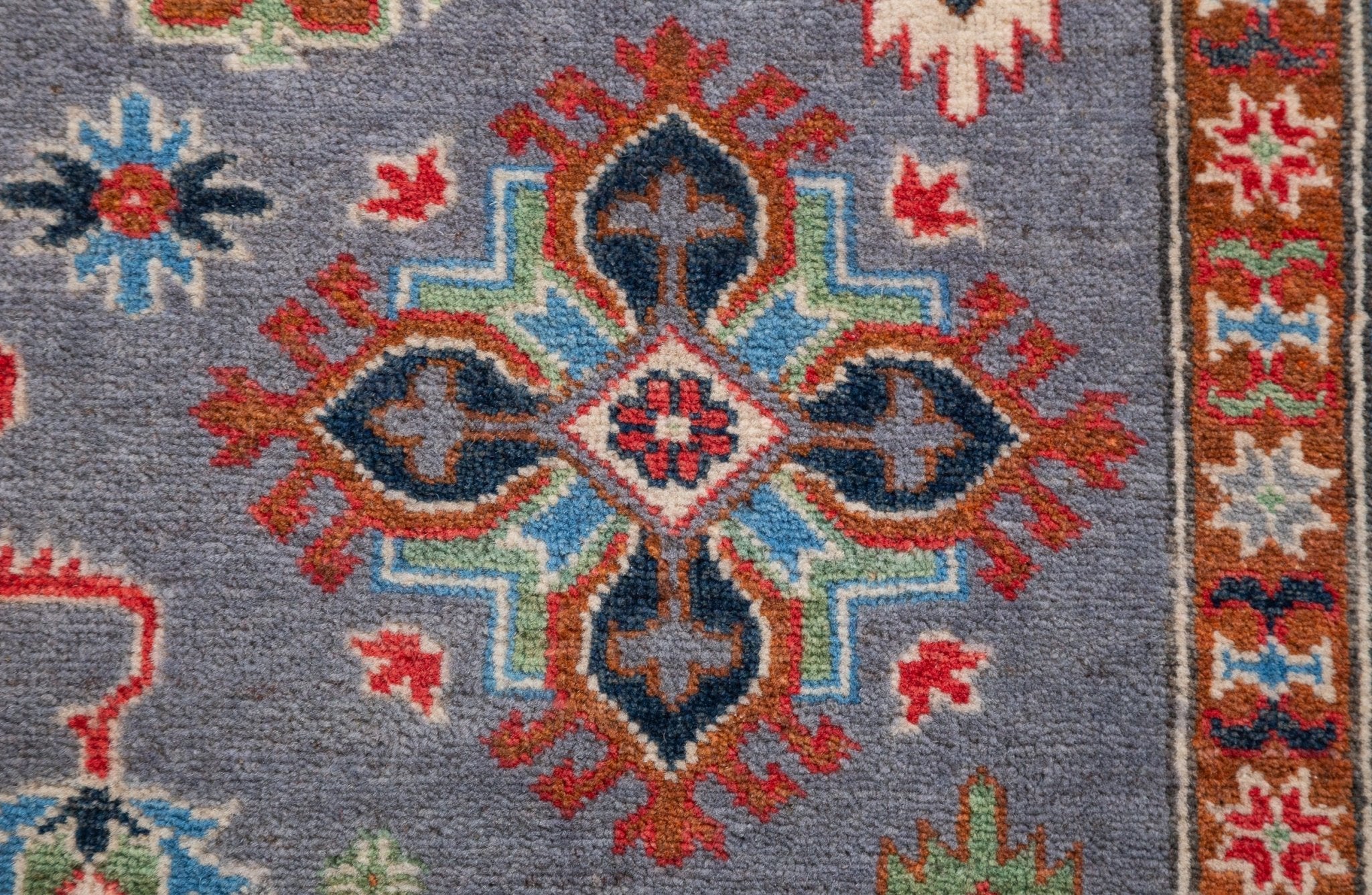 Pattern detail of blue & red Kazak-inspired wool rug 29339.