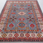 Full view from a low angle of blue & red Kazak-inspired wool rug 29339.