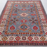 Full view from a low angle of blue & red Kazak-inspired wool rug 29339.