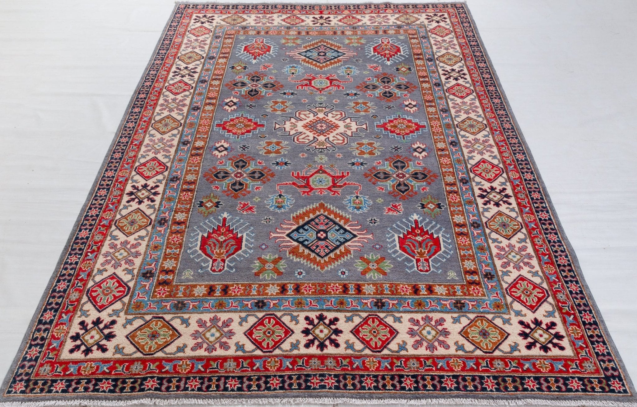 Full view from a low angle of blue & red Kazak-inspired wool rug 29339.
