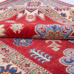 Folded edge and wool pile of red & ivory Kazak-inspired wool rug 21991.