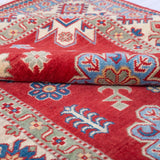 Folded edge and wool pile of red & ivory Kazak-inspired wool rug 21991.