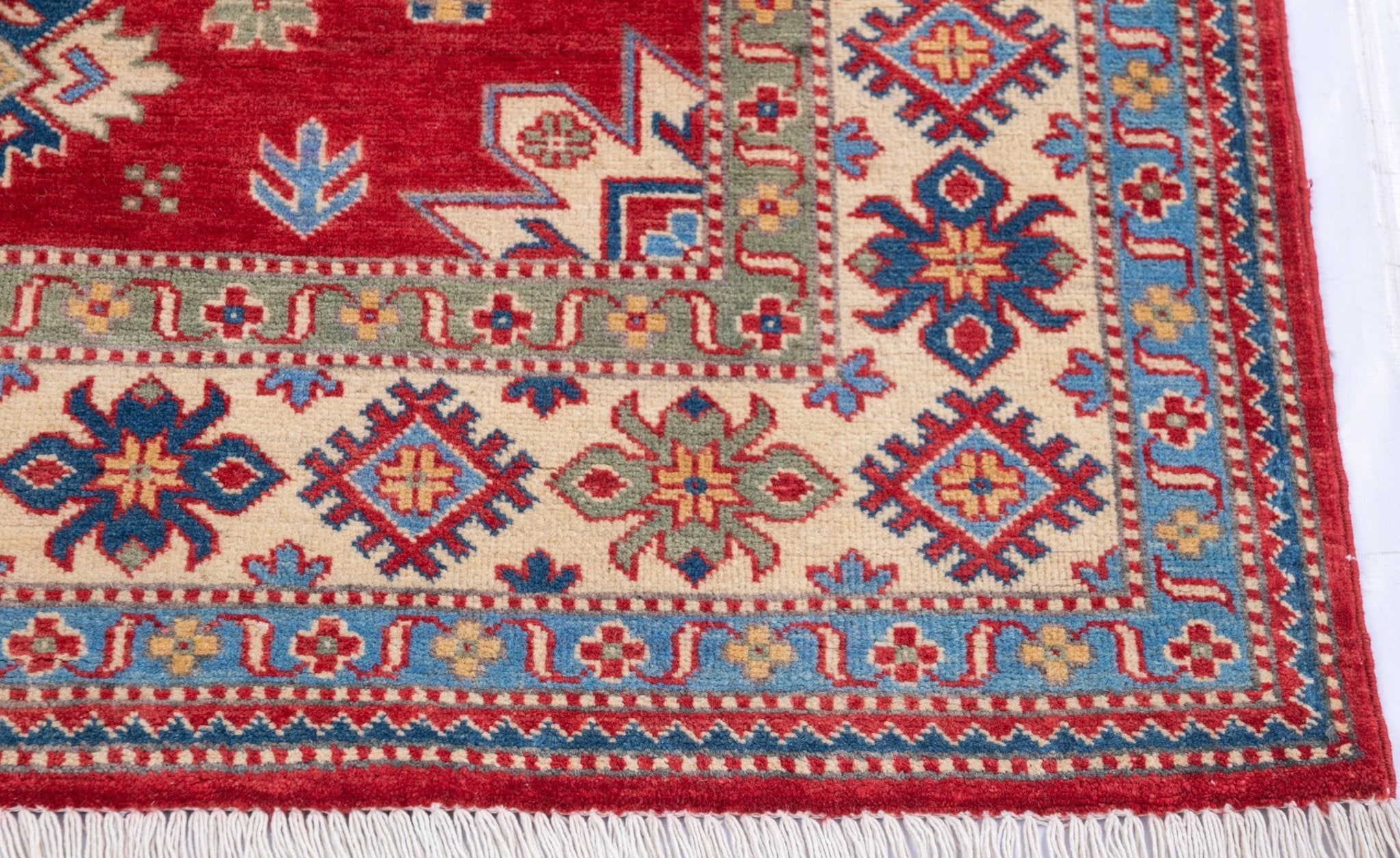 Border and edge detail of red & ivory Kazak-inspired wool rug 21991.