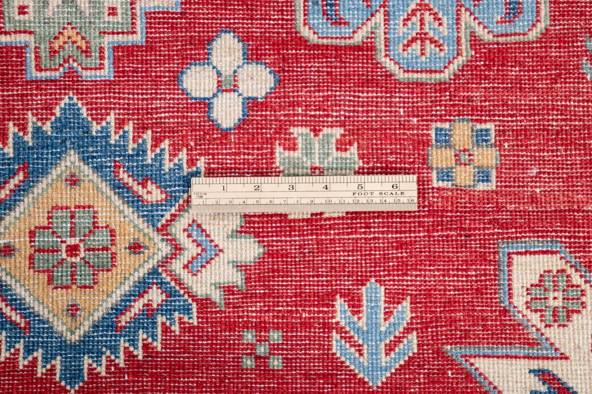 Wool pile close-up of red & ivory Kazak-inspired wool rug 21991.