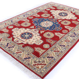 Full view at an angle of red & ivory Kazak-inspired wool rug 22082.