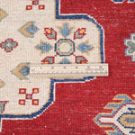 Folded edge and wool pile of red & ivory Kazak-inspired wool rug 22082.