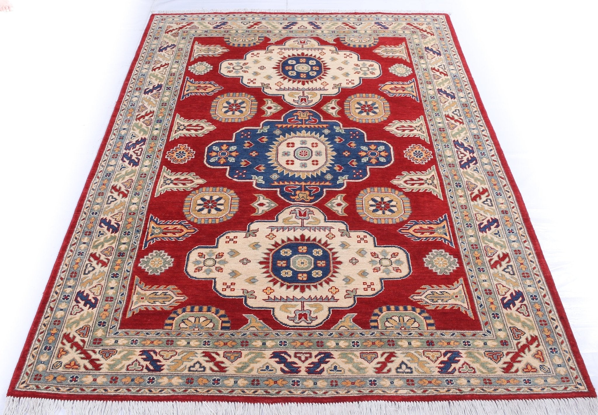 Full view from a low angle of red & ivory Kazak-inspired wool rug 22082.