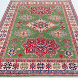 Full view from a low angle of green & red Kazak-inspired wool rug 29641.