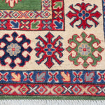 Border and edge detail of green & red Kazak-inspired wool rug 29641.
