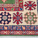 Border and edge detail of green & red Kazak-inspired wool rug 29641.