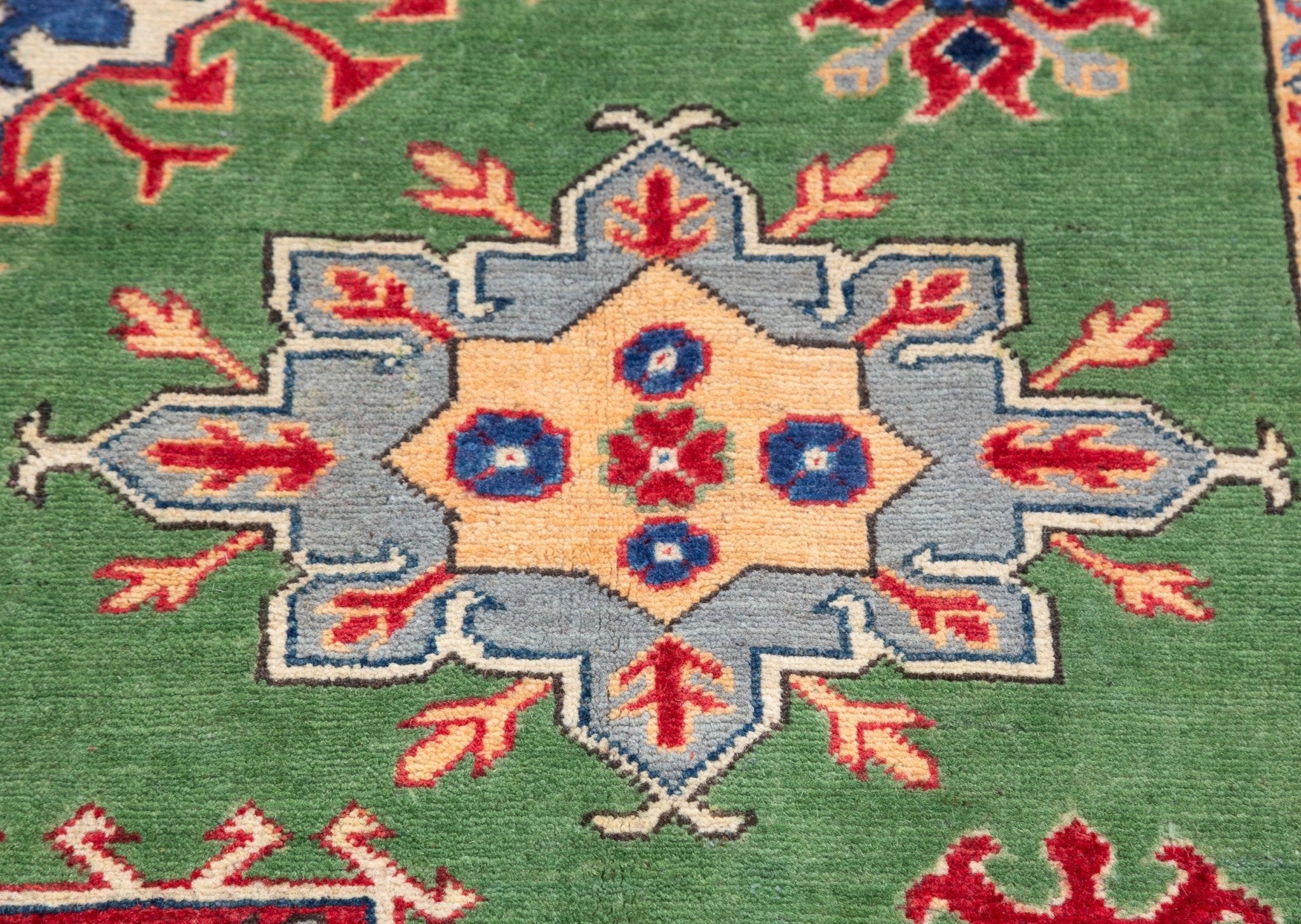Pattern detail of green & red Kazak-inspired wool rug 29641.