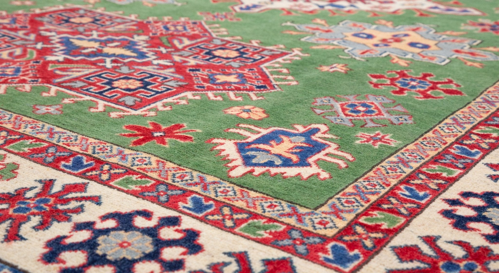 Pattern detail of green & red Kazak-inspired wool rug 29641.
