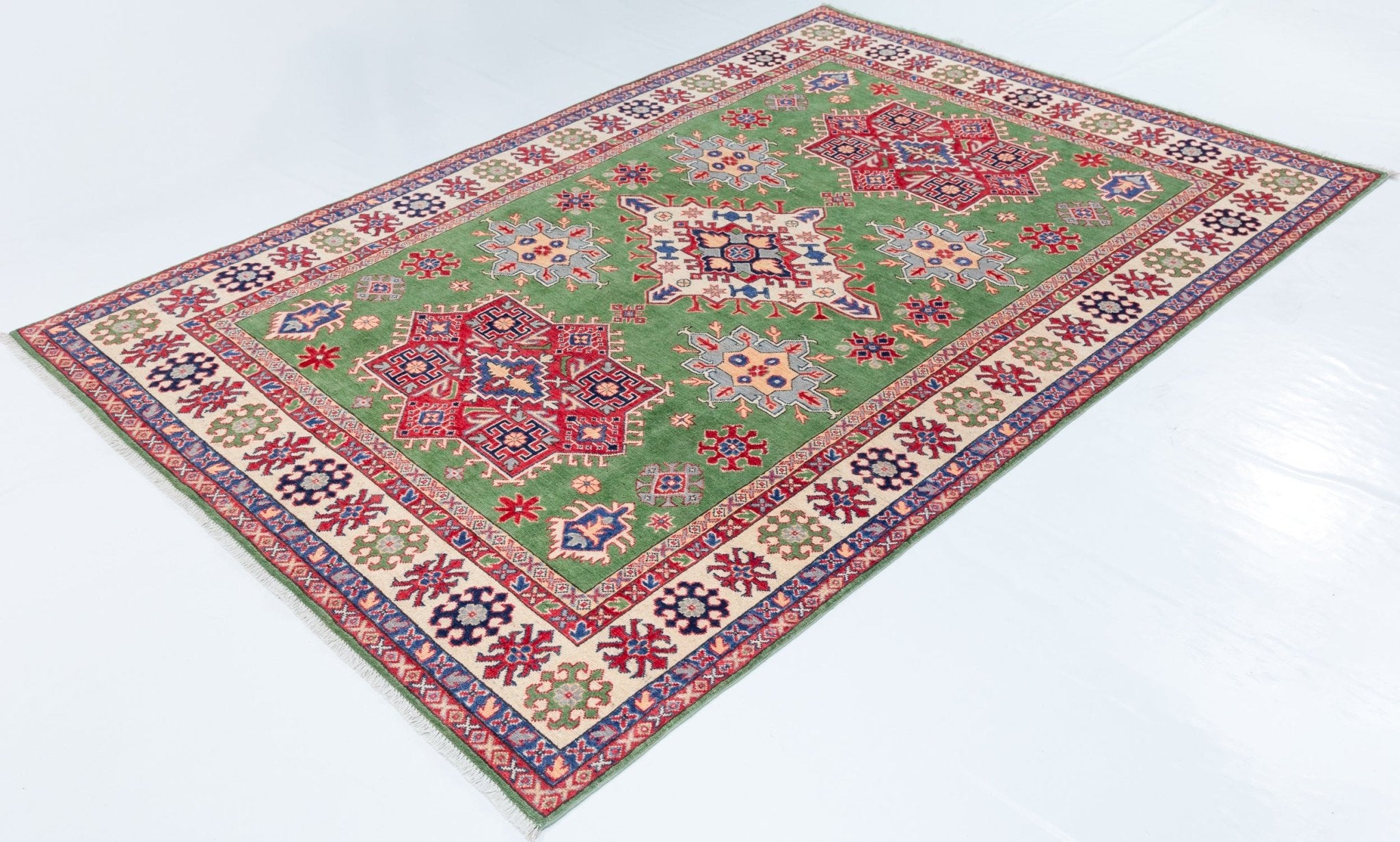 Full view at an angle of green & red Kazak-inspired wool rug 29641.