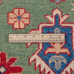 Wool pile close-up of green & red Kazak-inspired wool rug 29641.