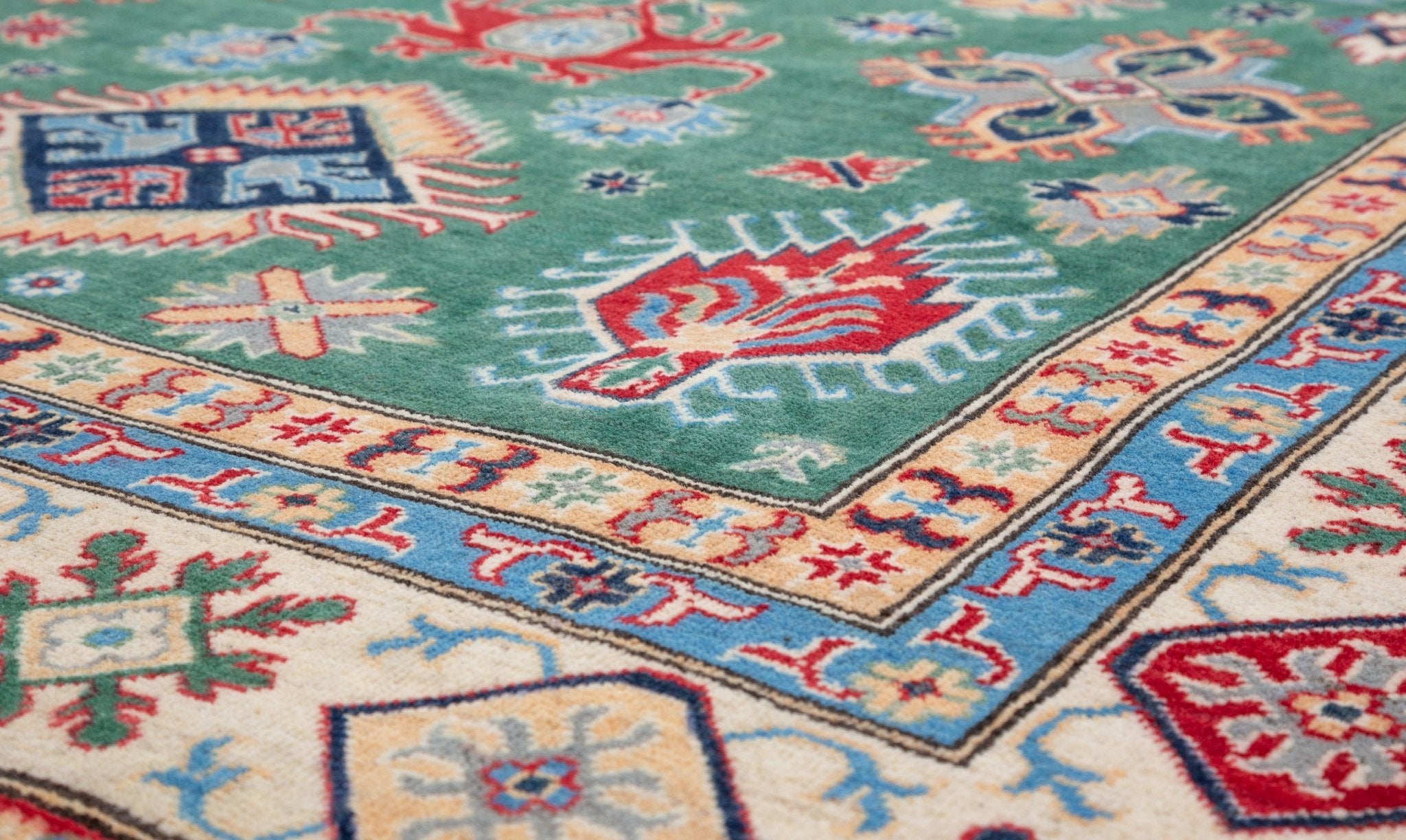 Pattern detail of green & ivory Kazak-inspired wool rug 29640.