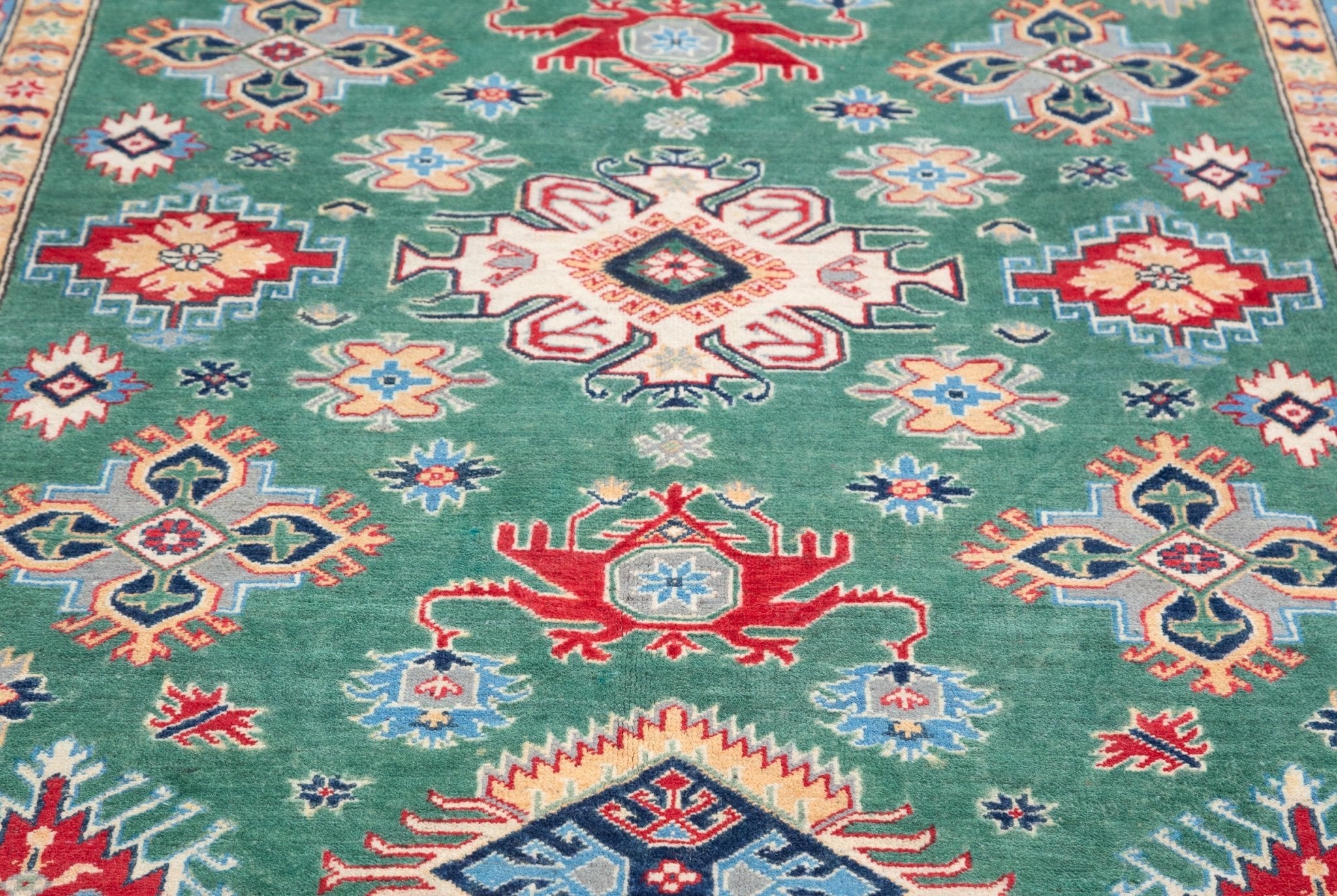 Pattern detail of green & ivory Kazak-inspired wool rug 29640.