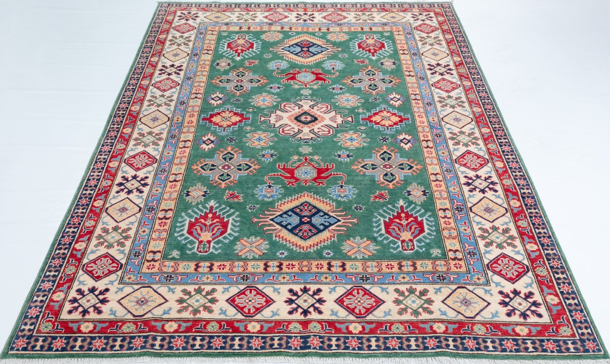 Full view from a low angle of green & ivory Kazak-inspired wool rug 29640.