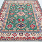 Full view from a low angle of green & ivory Kazak-inspired wool rug 29640.
