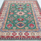 Full view from a low angle of green & ivory Kazak-inspired wool rug 29640.