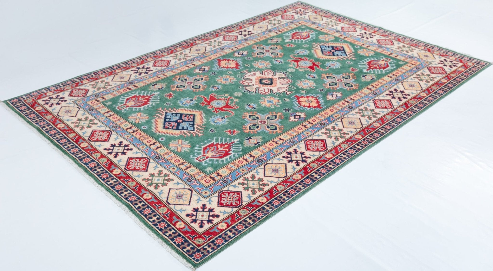 Full view at an angle of green & ivory Kazak-inspired wool rug 29640.