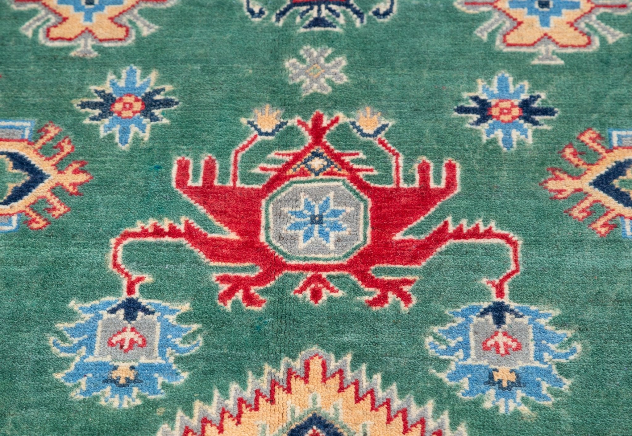 Pattern detail of green & ivory Kazak-inspired wool rug 29640.