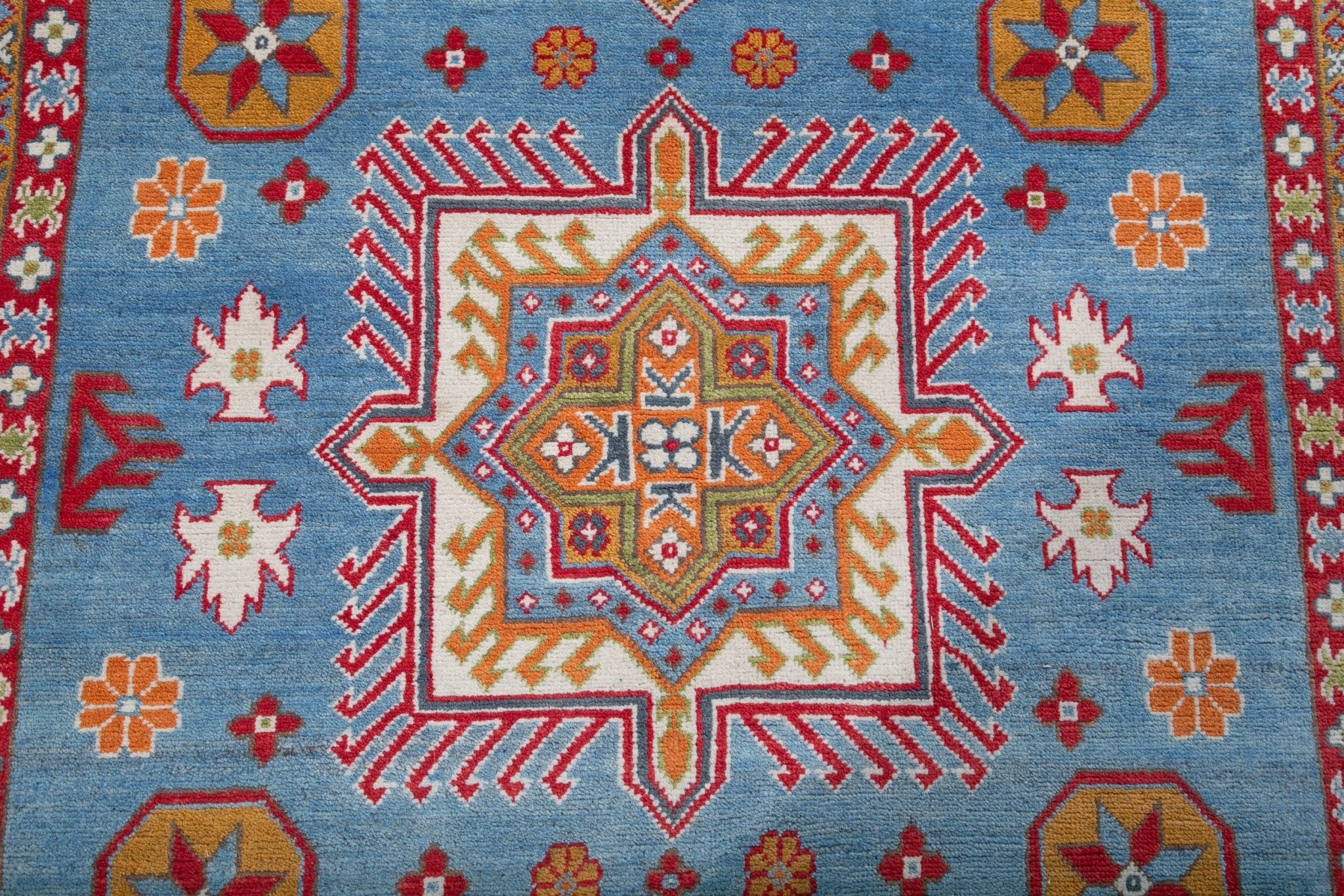 Pattern detail of blue & red Kazak-inspired wool rug 24986.