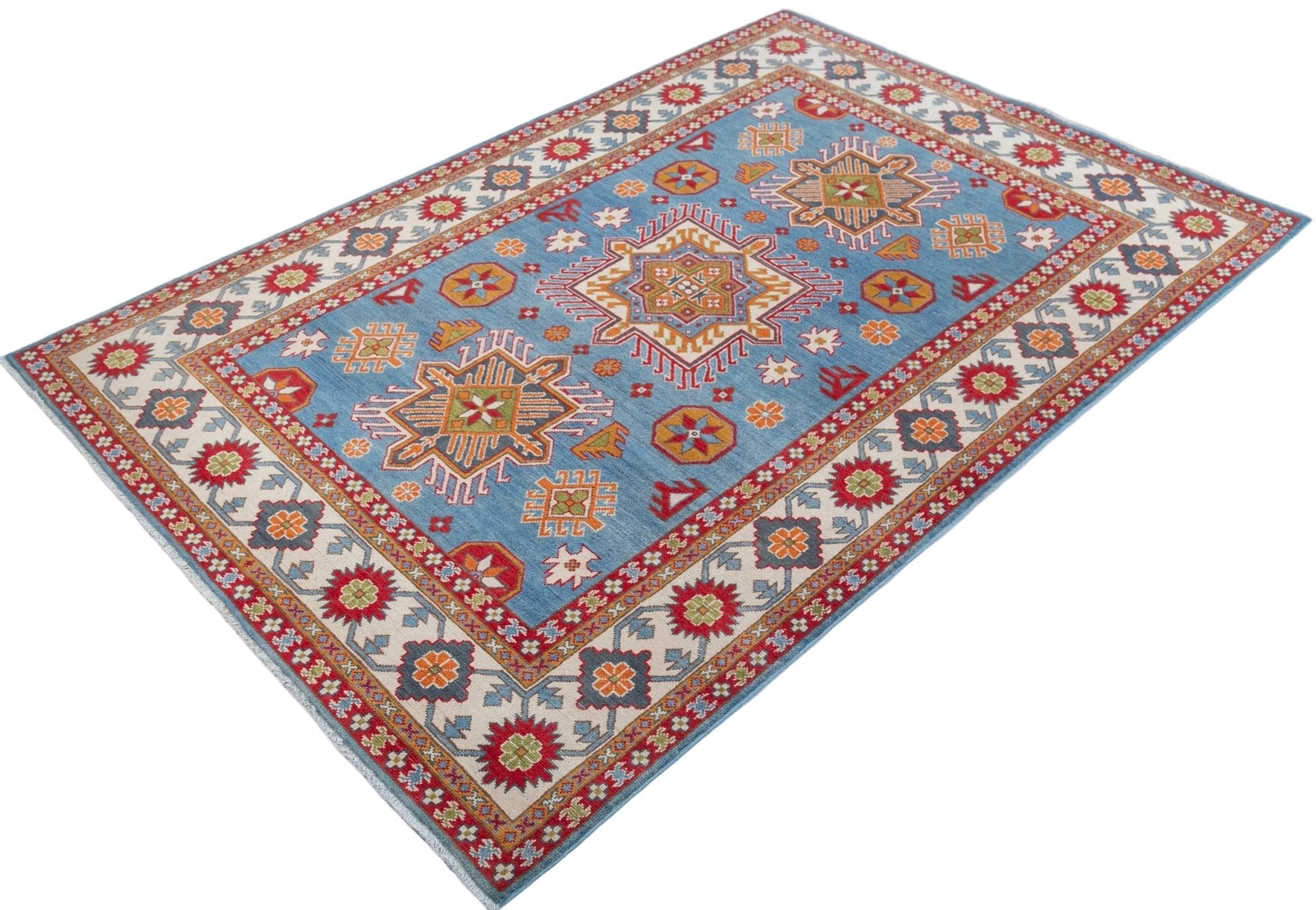 Full view at an angle of blue & red Kazak-inspired wool rug 24986.