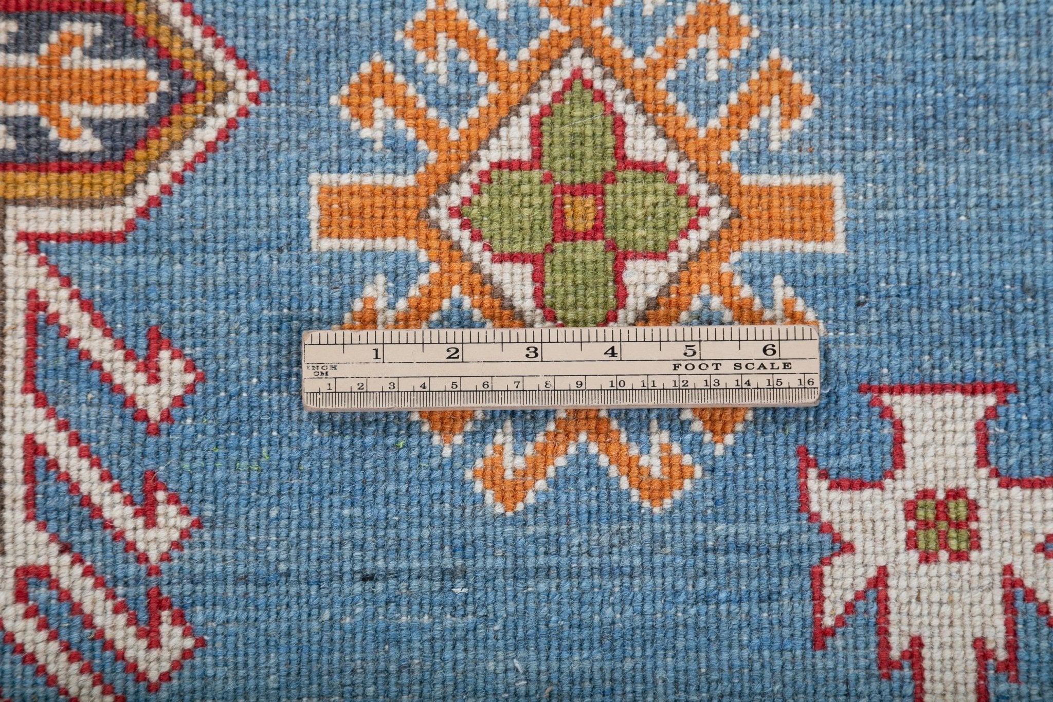 Wool pile close-up of blue & red Kazak-inspired wool rug 24986.