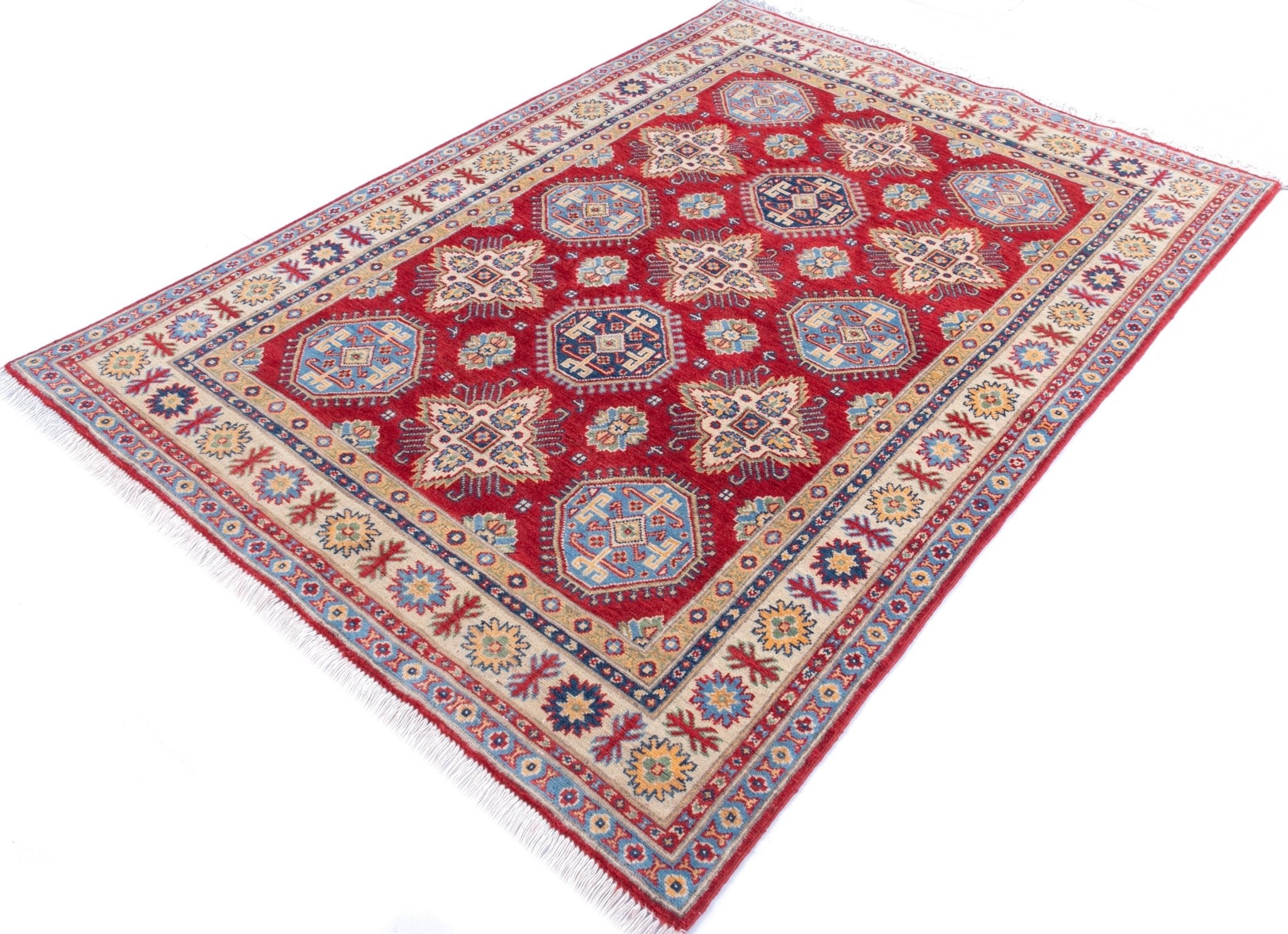 Full view at an angle of red & blue Kazak-inspired wool rug 21988.