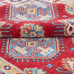 Folded edge and wool pile of red & blue Kazak-inspired wool rug 21988.