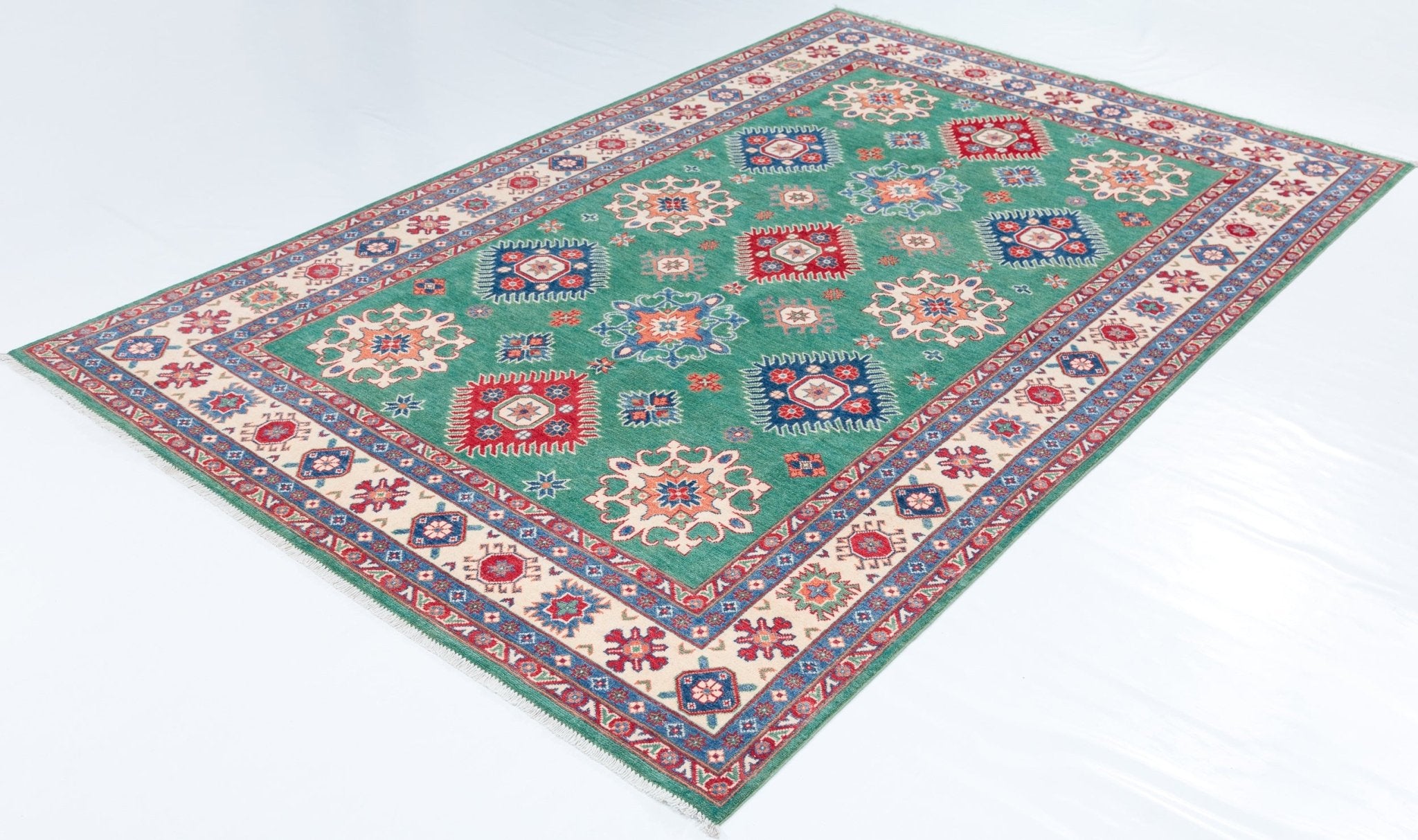 Full view at an angle of green & blue Kazak-inspired wool rug 29639.