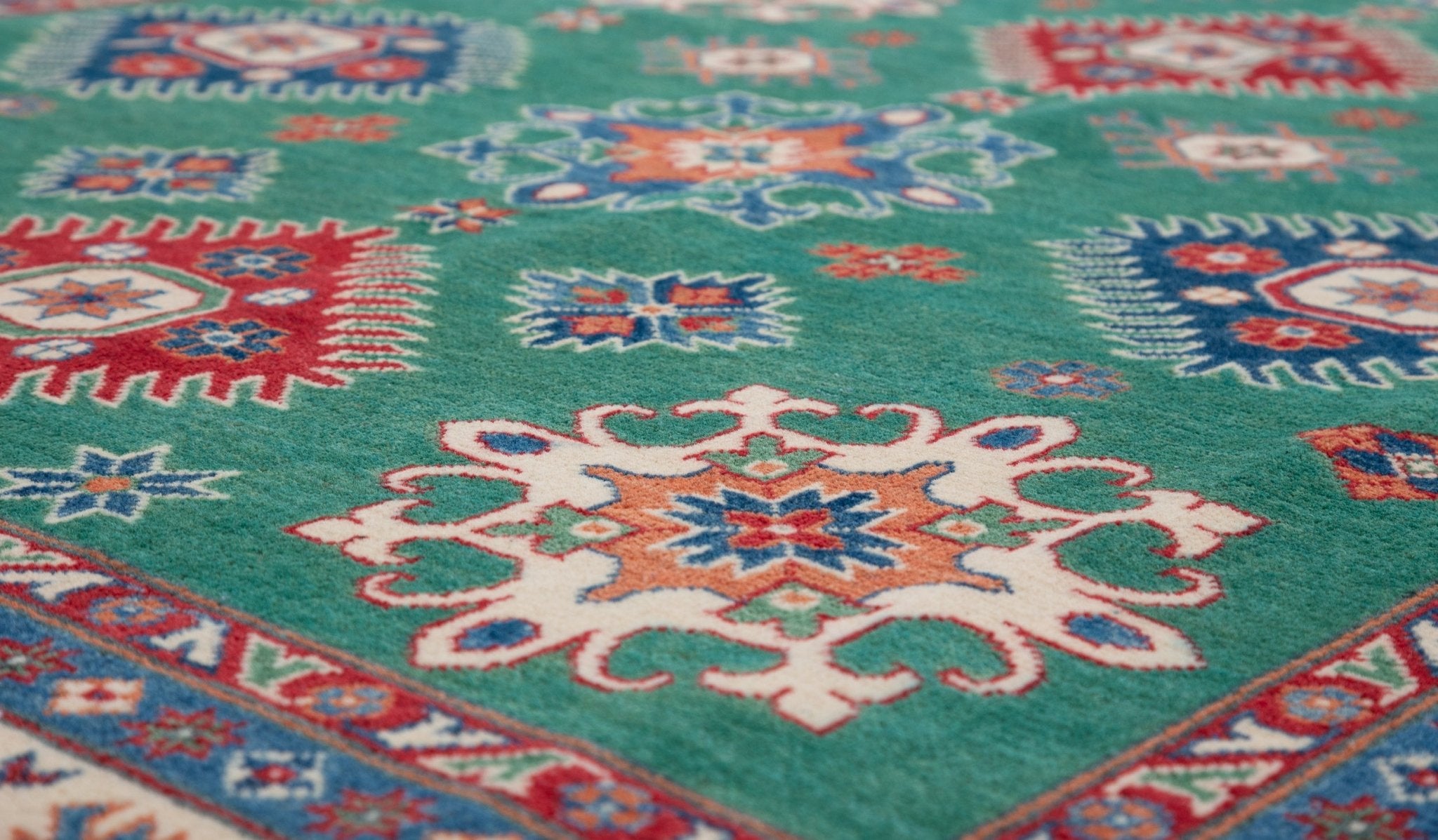 Pattern detail of green & blue Kazak-inspired wool rug 29639.