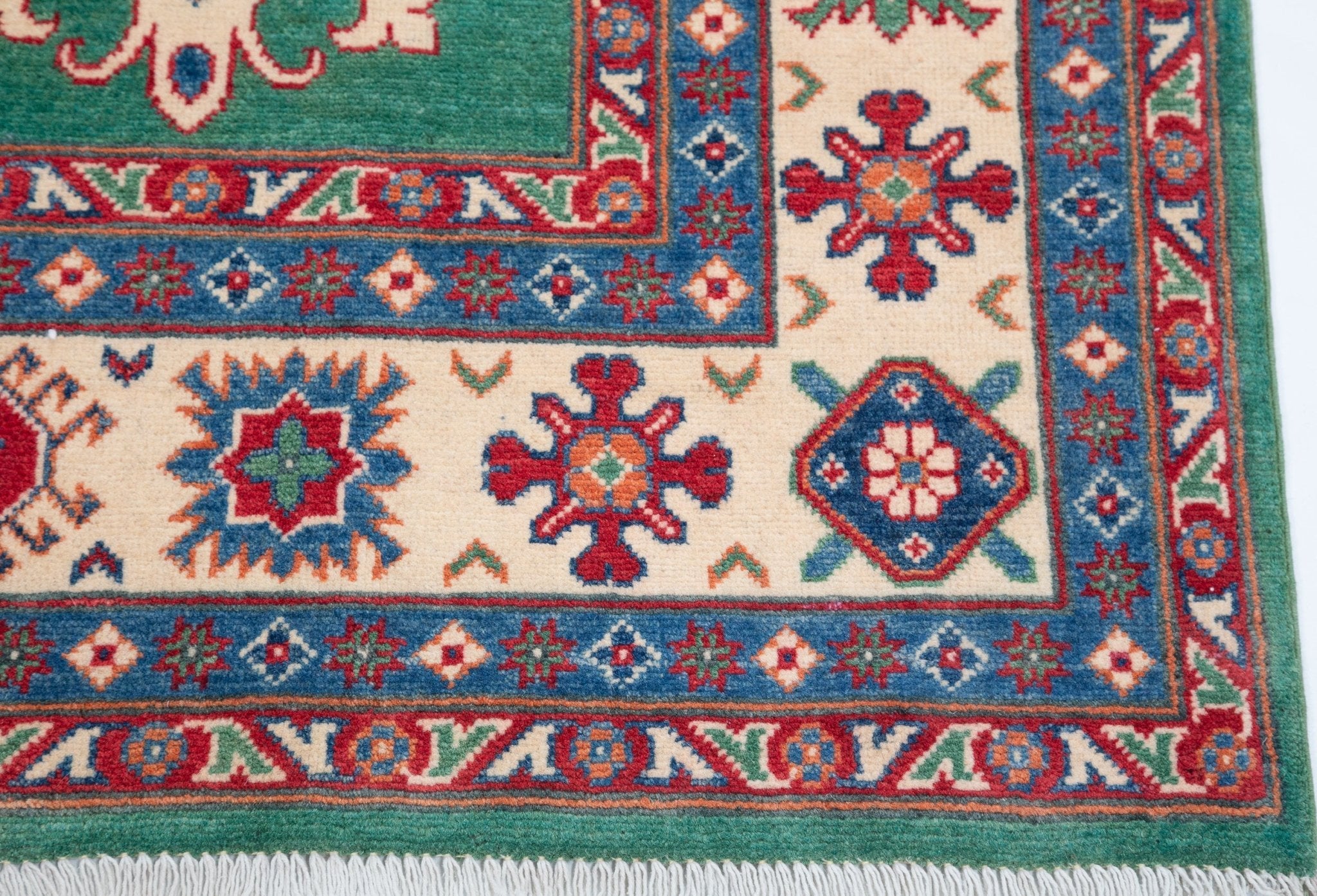 Border and edge detail of green & blue Kazak-inspired wool rug 29639.