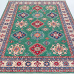 Full view from a low angle of green & blue Kazak-inspired wool rug 29639.