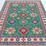 Full view from a low angle of green & blue Kazak-inspired wool rug 29639.