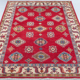 Full view from a low angle of red & blue Kazak-inspired wool rug 24995.