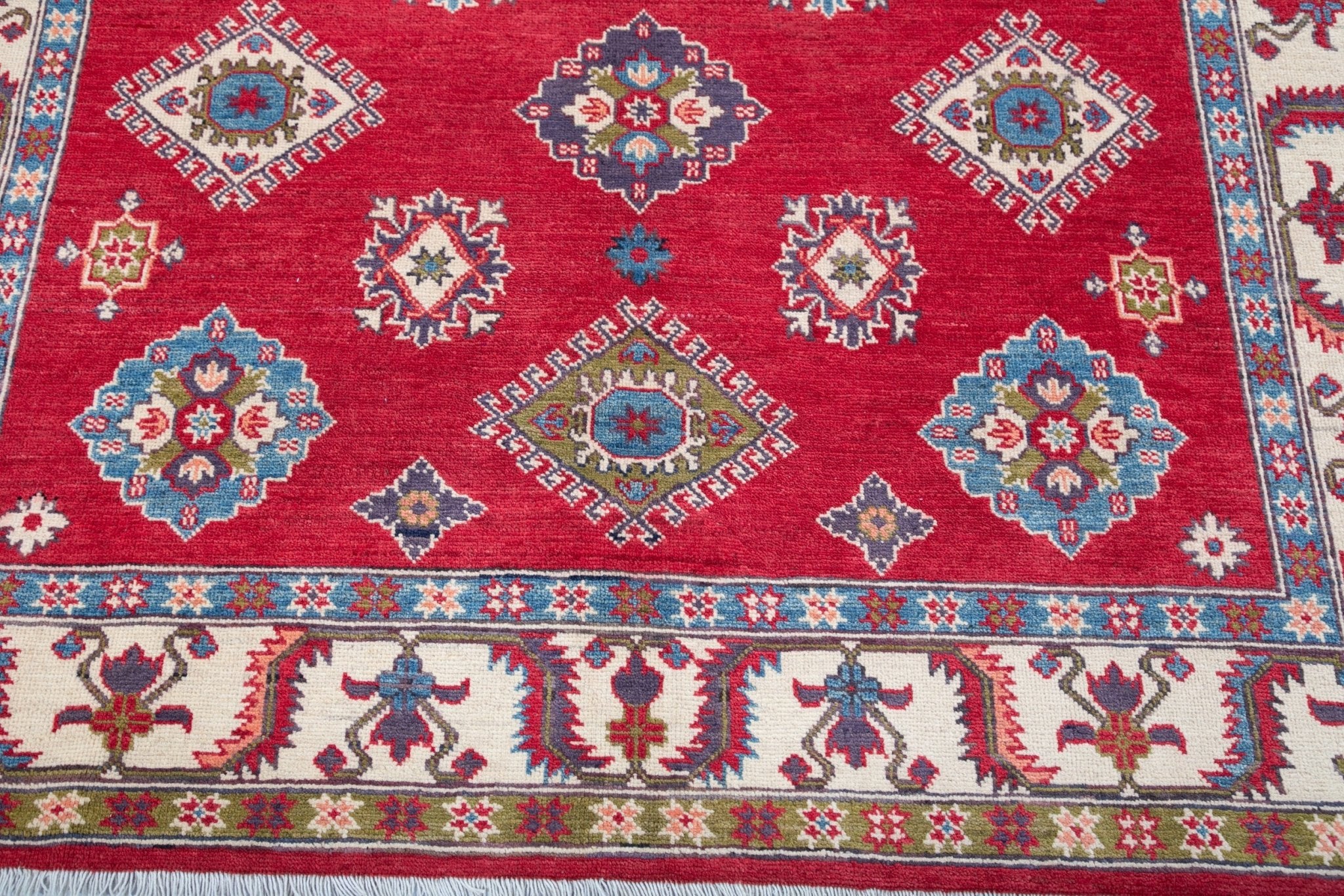 Pattern detail of red & blue Kazak-inspired wool rug 24995.