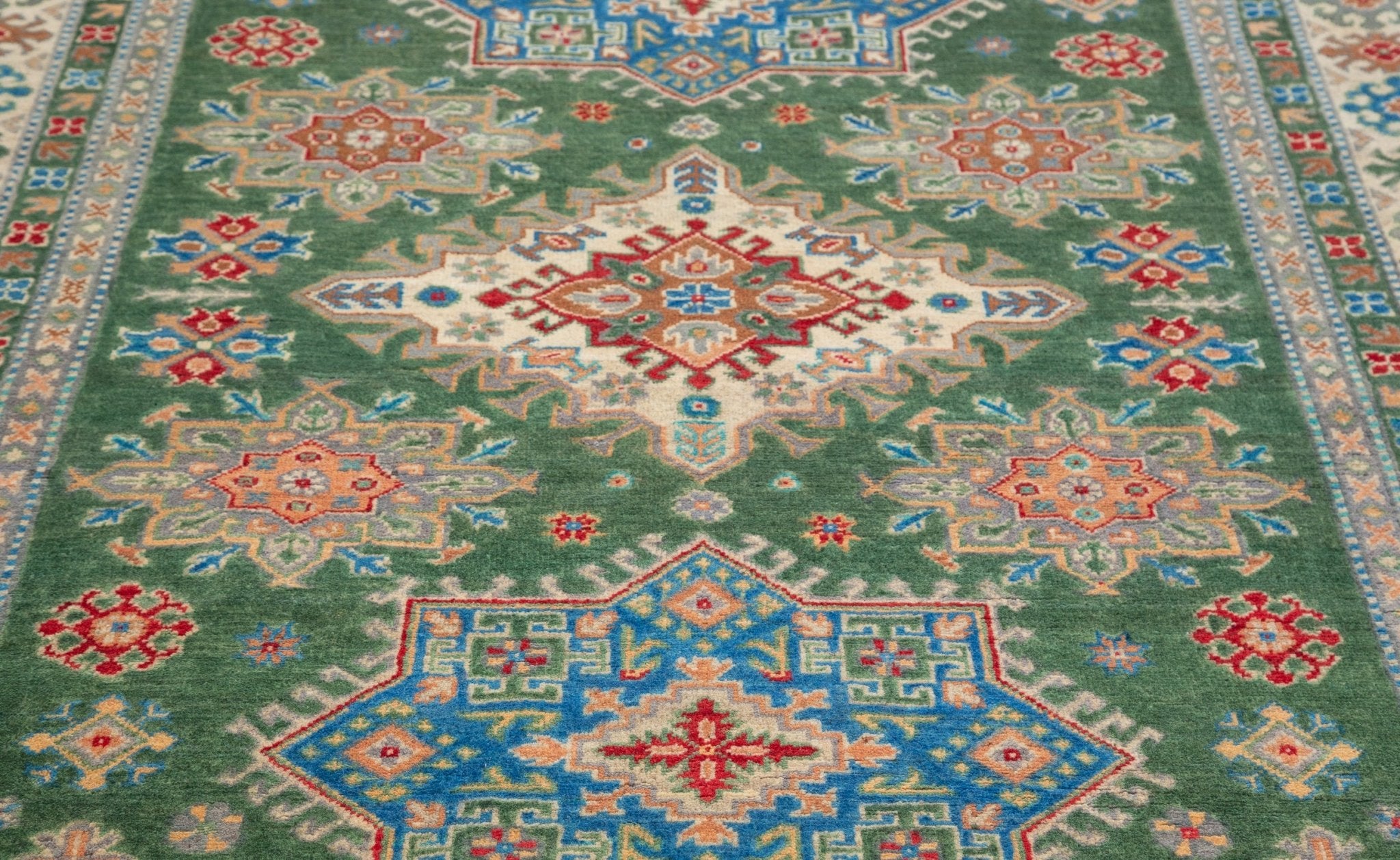 Pattern detail of green & blue Kazak-inspired wool rug 29637.