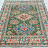 Full view from a low angle of green & blue Kazak-inspired wool rug 29637.