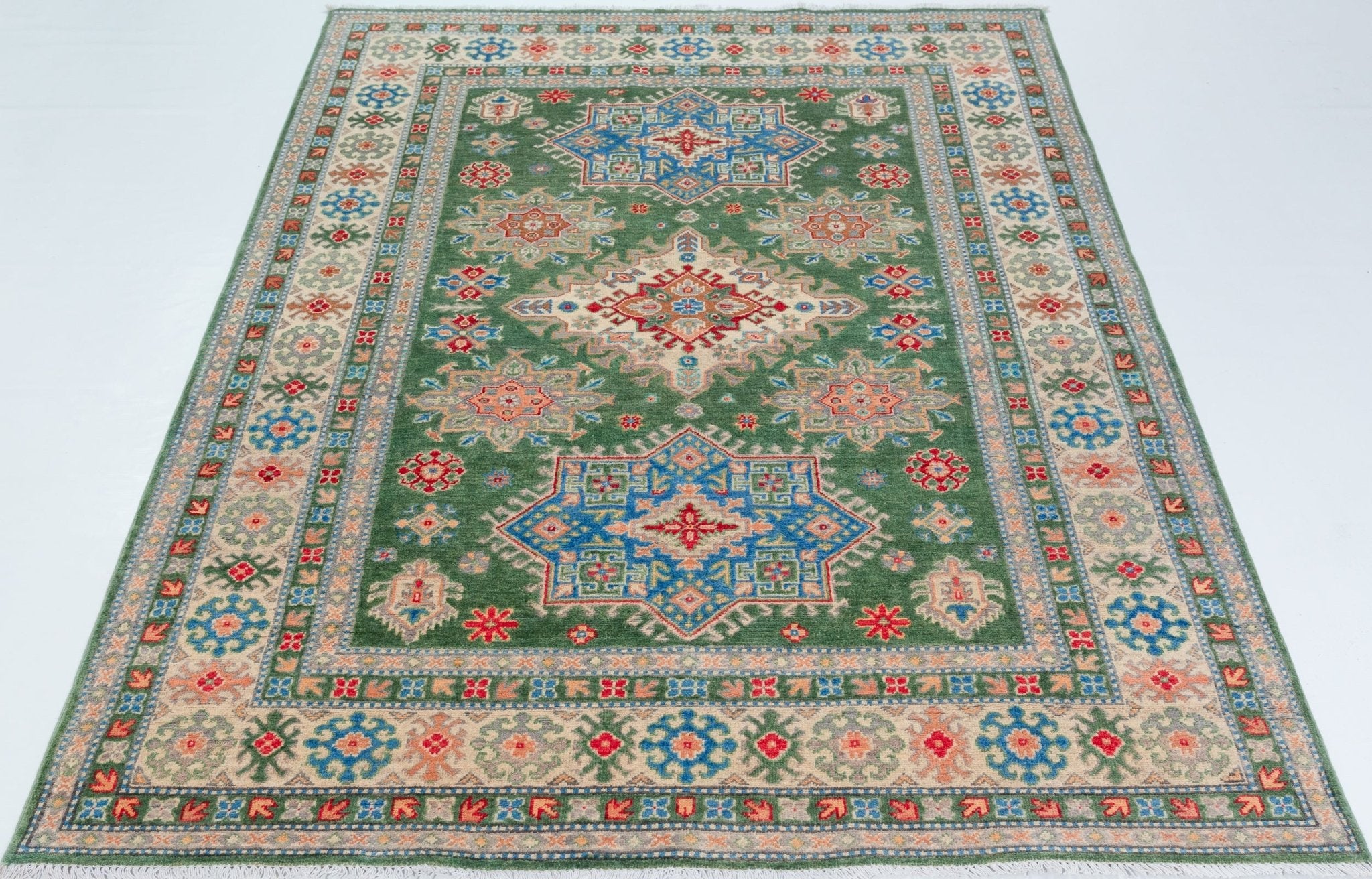 Full view from a low angle of green & blue Kazak-inspired wool rug 29637.