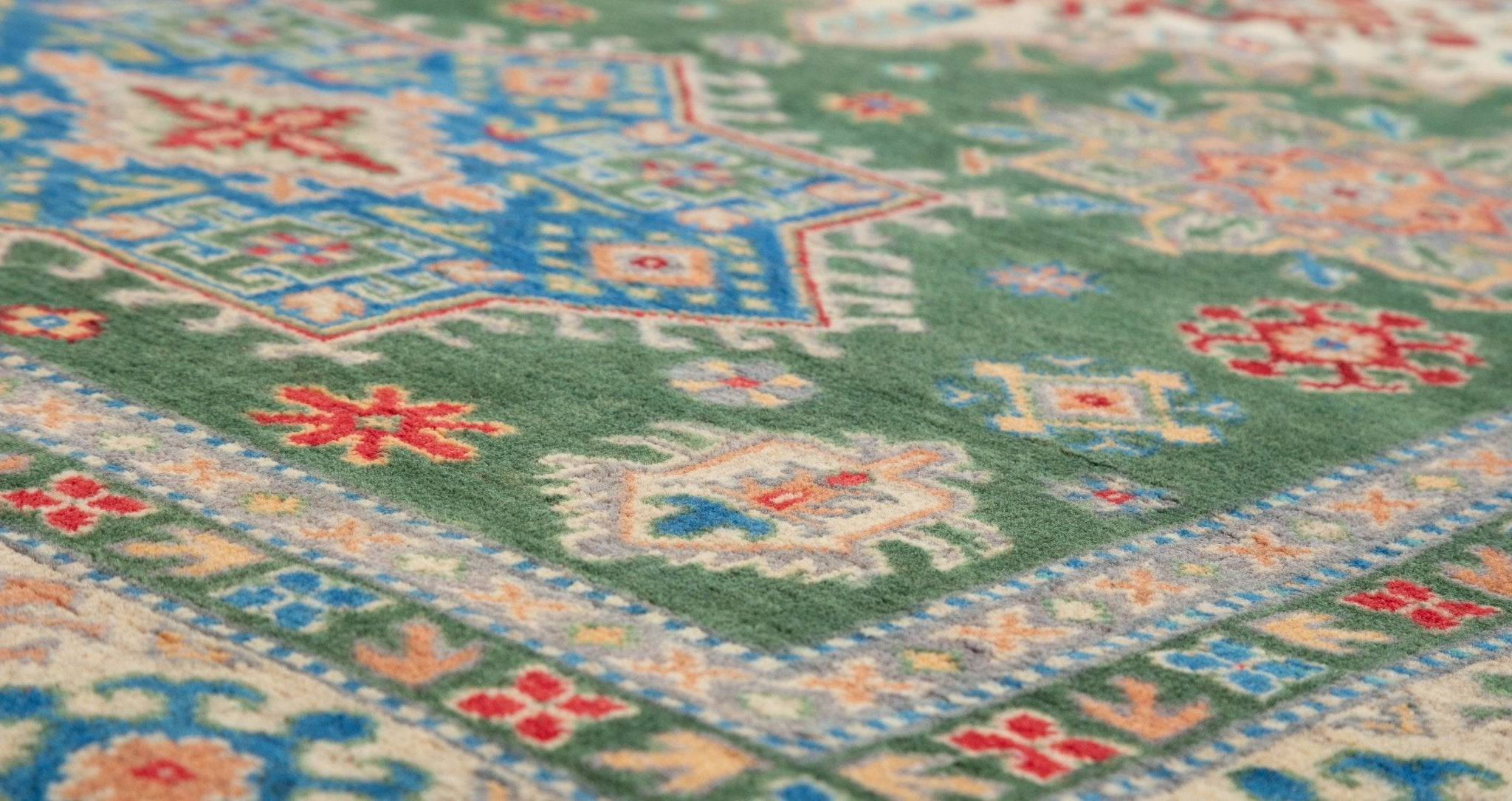 Pattern detail of green & blue Kazak-inspired wool rug 29637.