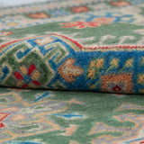 Folded edge and wool pile of green & blue Kazak-inspired wool rug 29637.