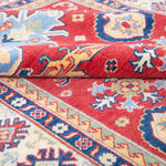 Folded edge and wool pile of red & ivory Kazak-inspired wool rug 21989.