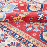 Folded edge and wool pile of red & ivory Kazak-inspired wool rug 21989.
