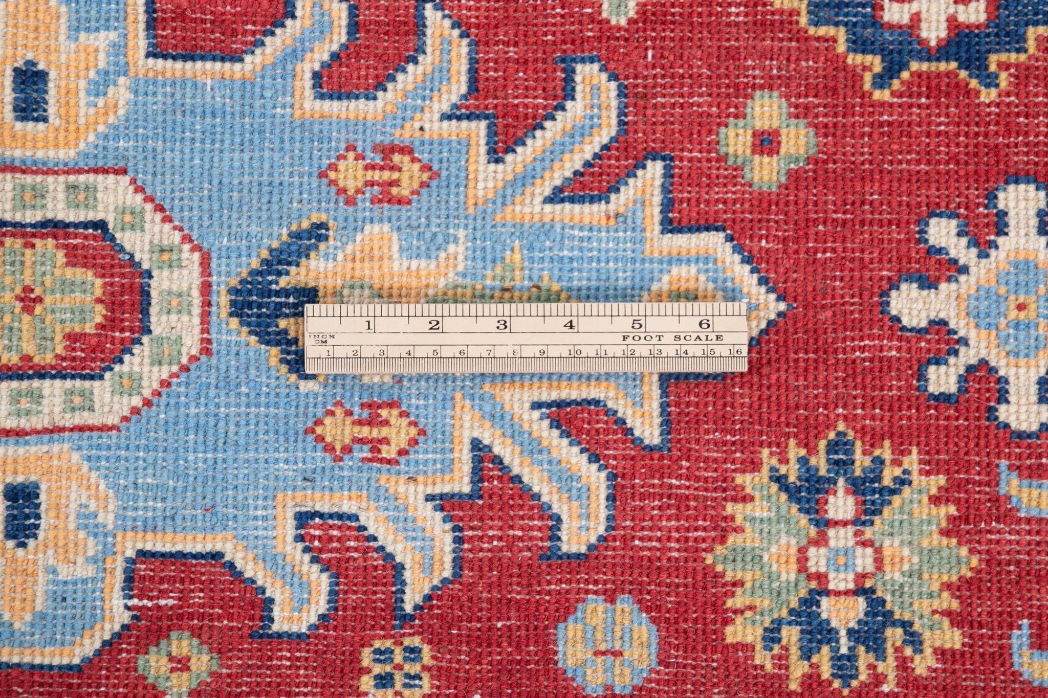 Wool pile close-up of red & ivory Kazak-inspired wool rug 21989.