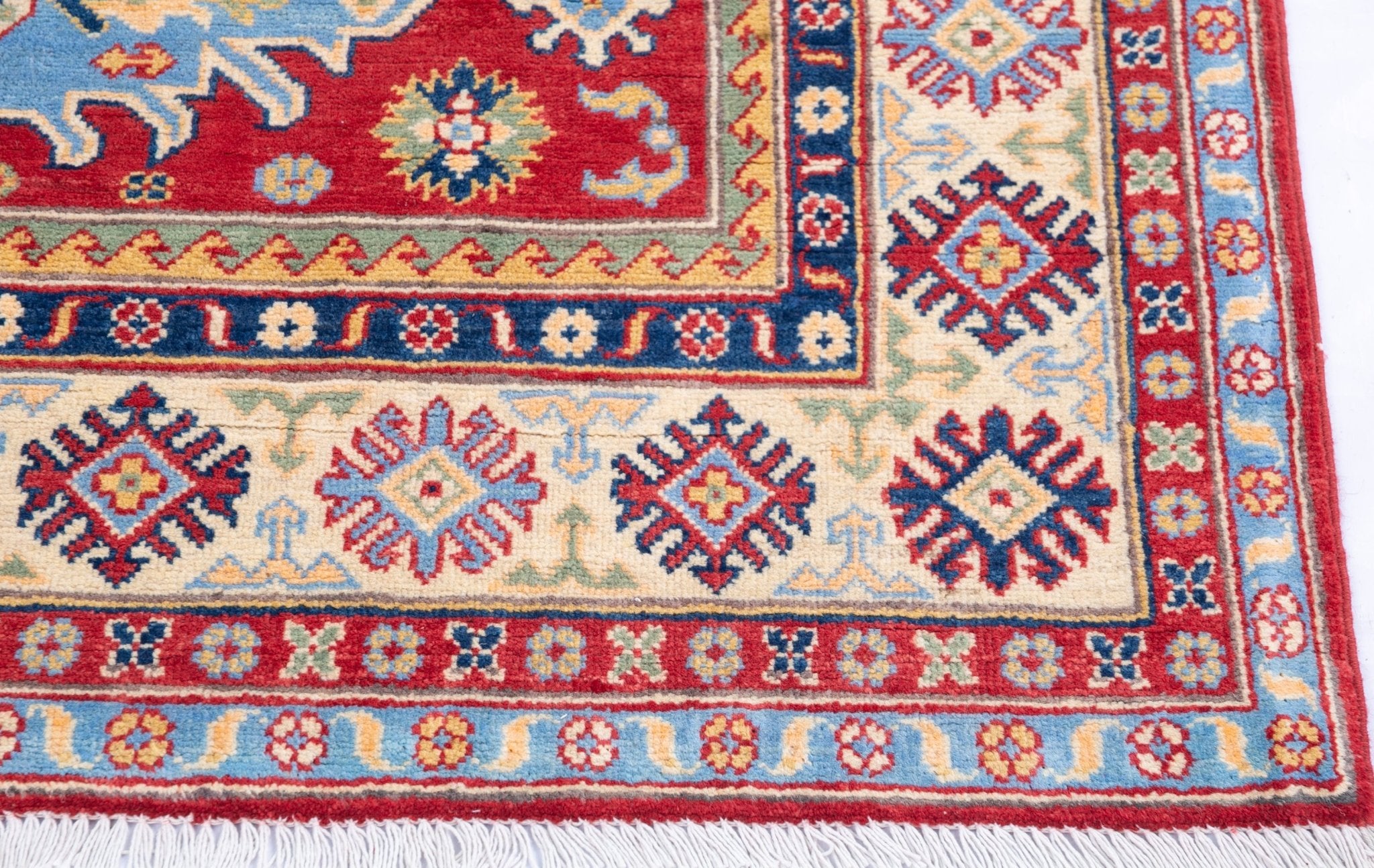 Border and edge detail of red & ivory Kazak-inspired wool rug 21989.