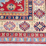 Border and edge detail of red & ivory Kazak-inspired wool rug 21989.