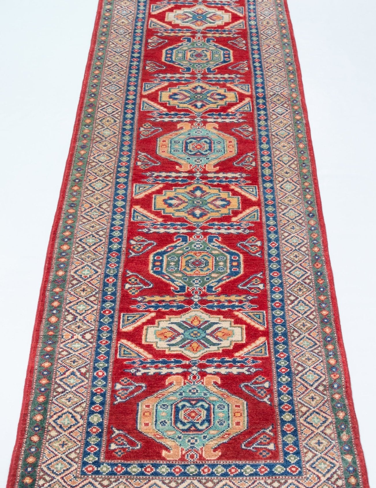 Full view from a low angle of red & blue Kazak-inspired wool runner 29654.